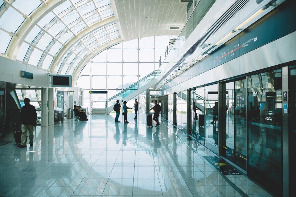 Bright airport terminal with travelers walking toward their gate
