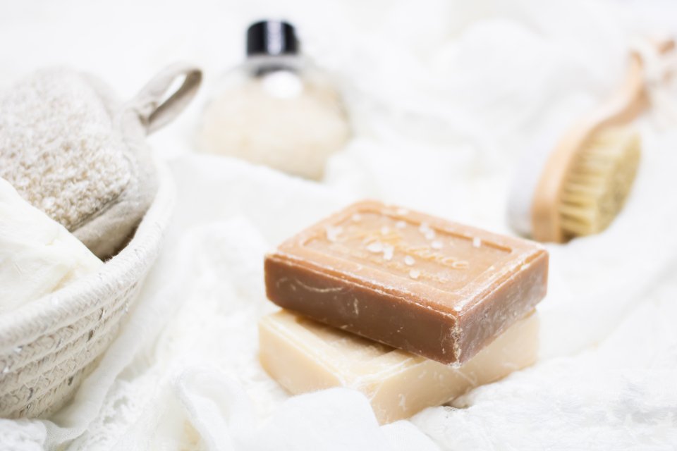 Luxury body scrub and spa soaps on soft linen