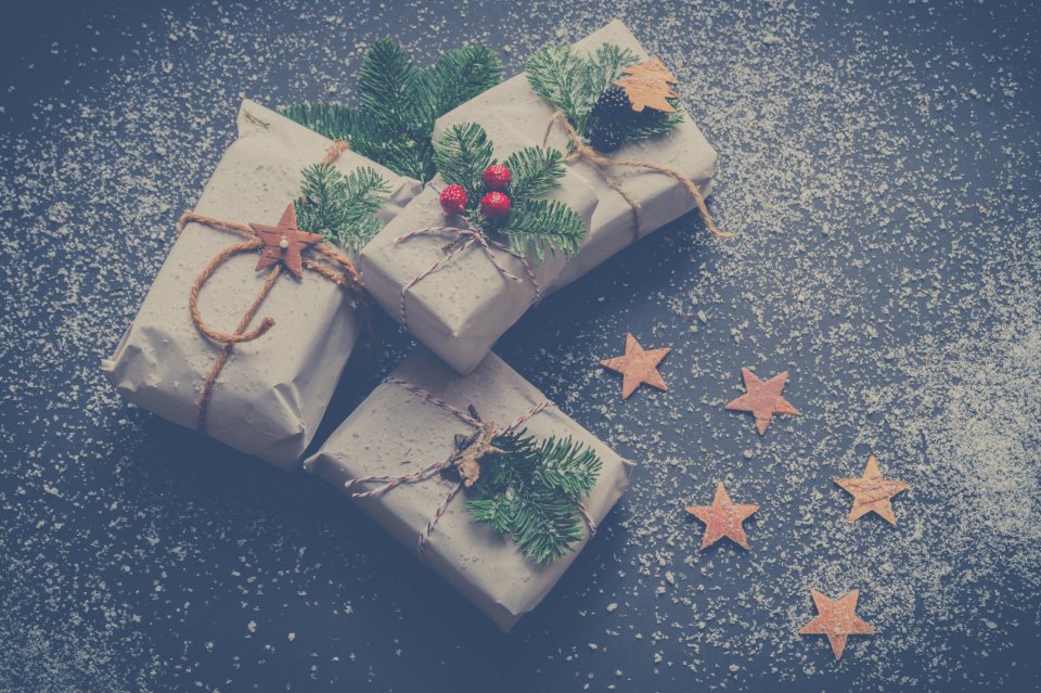 Kraft paper Christmas gifts tied with string and pine sprigs