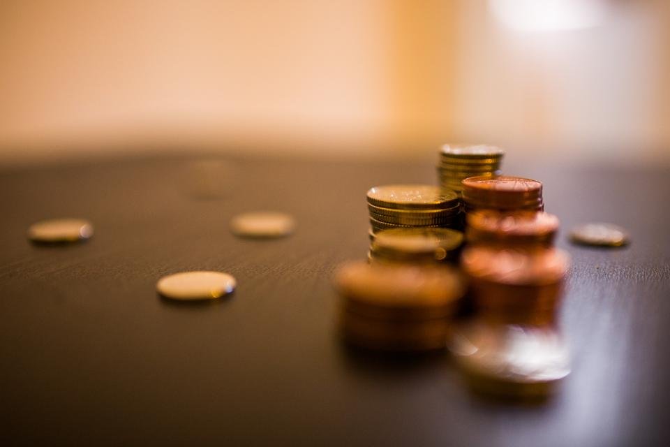 Gender pay gap illustrated with stacks of coins on a table