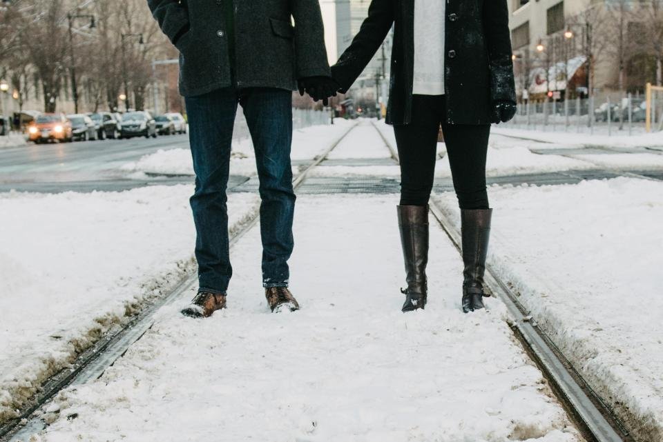 Boots and tights on a snowy city street in winter