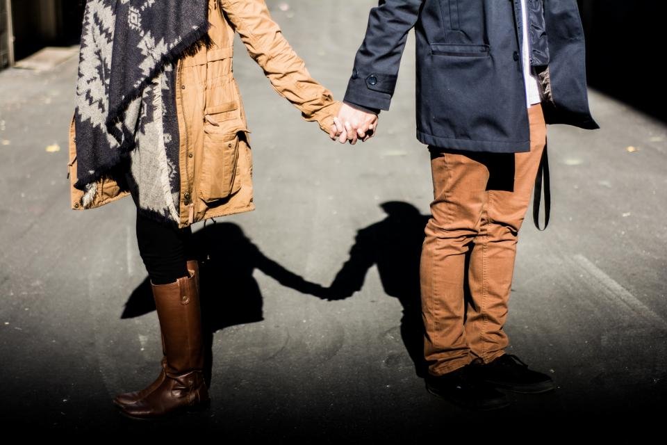 Couple holding hands, a sign of strong love compatibility
