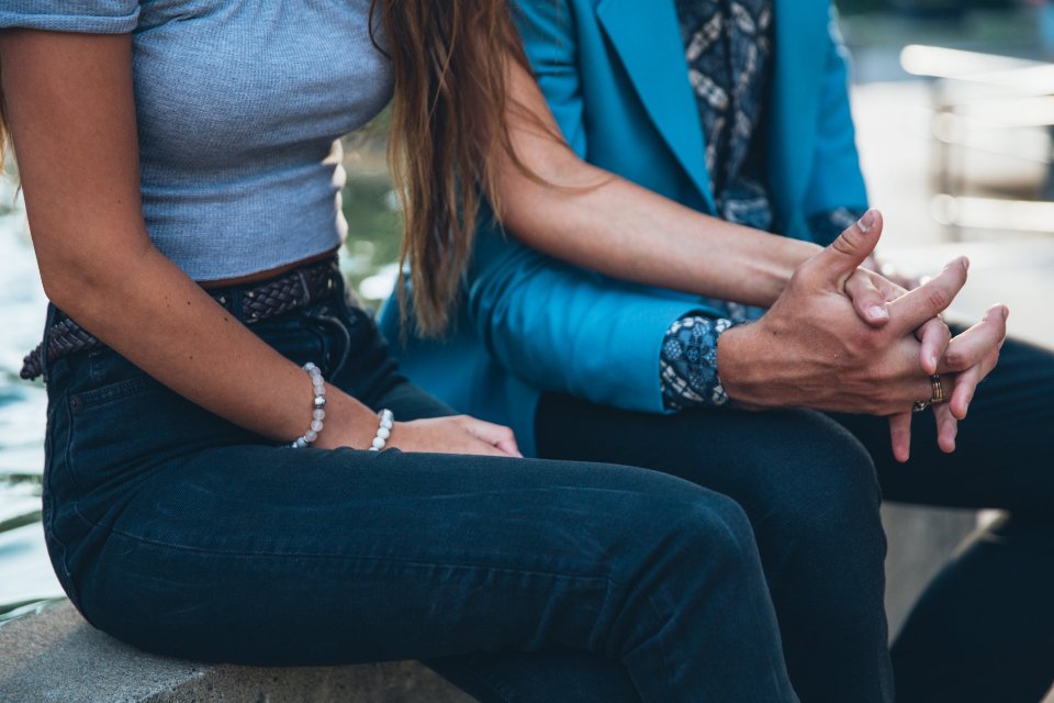 A couple sitting close together outdoors, a reminder that the best gifts for wife are personal