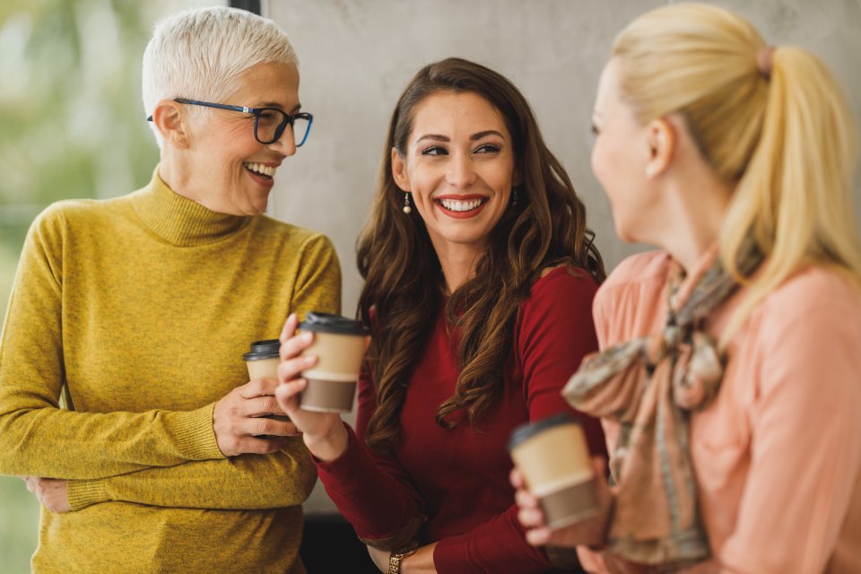 Colleagues chatting over coffee, inspiration for gifts for coworkers
