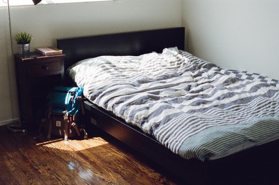 Mattress toppers on a cozy bed in a sunlit bedroom