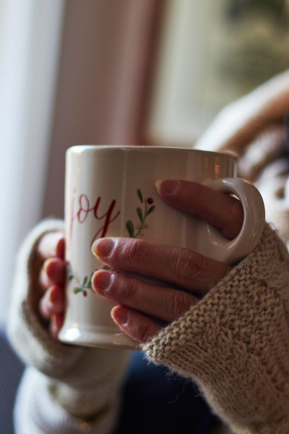 Cozy winter evening at home with warm drink and soft textiles