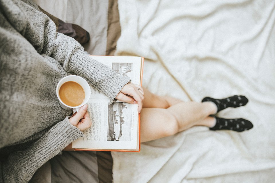 Cozy socks on a bed, a casual way to wear clogs at home