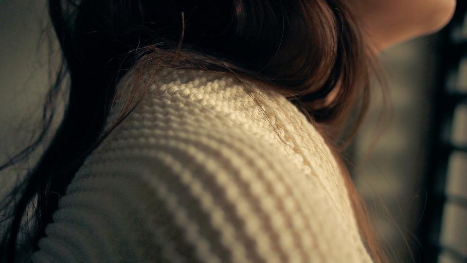 Close up of a soft cream knit sweater texture