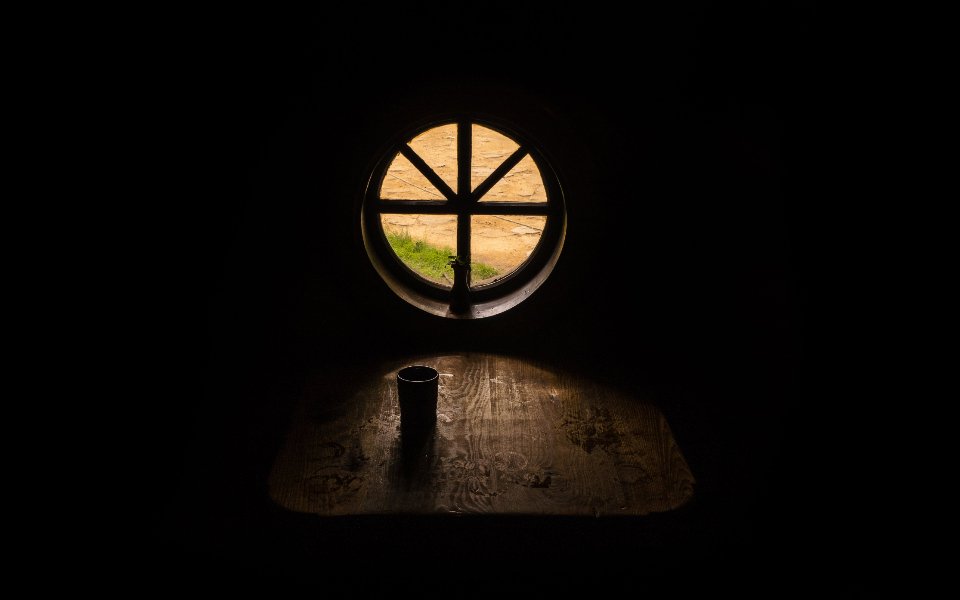 Dark room with a small window showing how light enters