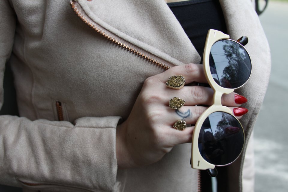 Woman holding a pair of the best designer sunglasses