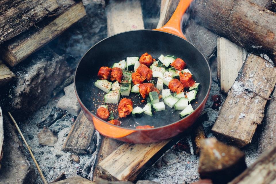 Cast iron skillet on a rustic table with fresh ingredients