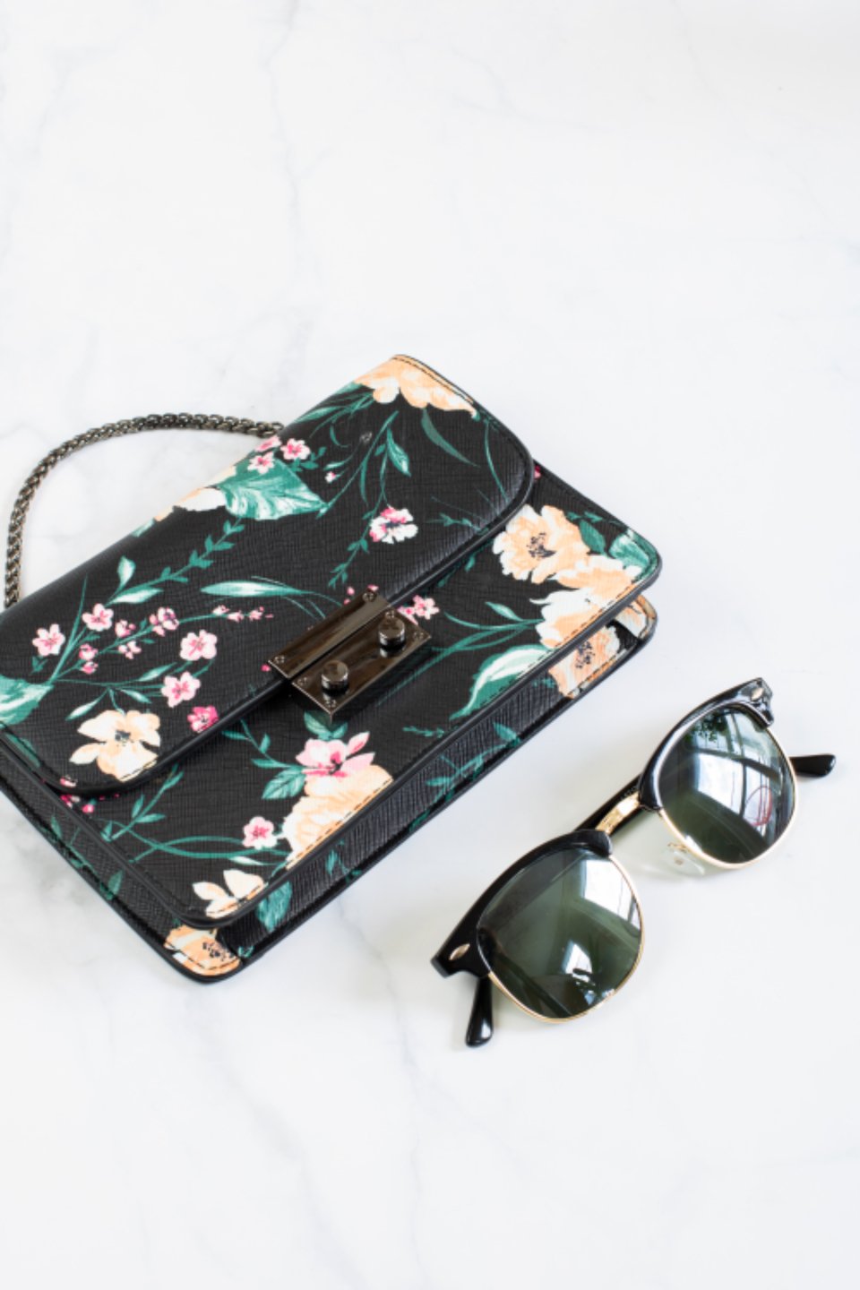 Best shoulder bags for women: a floral shoulder bag with sunglasses