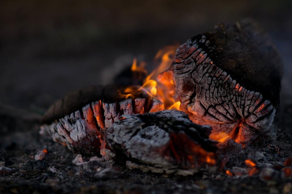 Glowing logs and embers in an outdoor fire