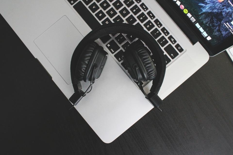 Over-ear headphones resting on a laptop, ideal for working with the best noise cancelling headphones