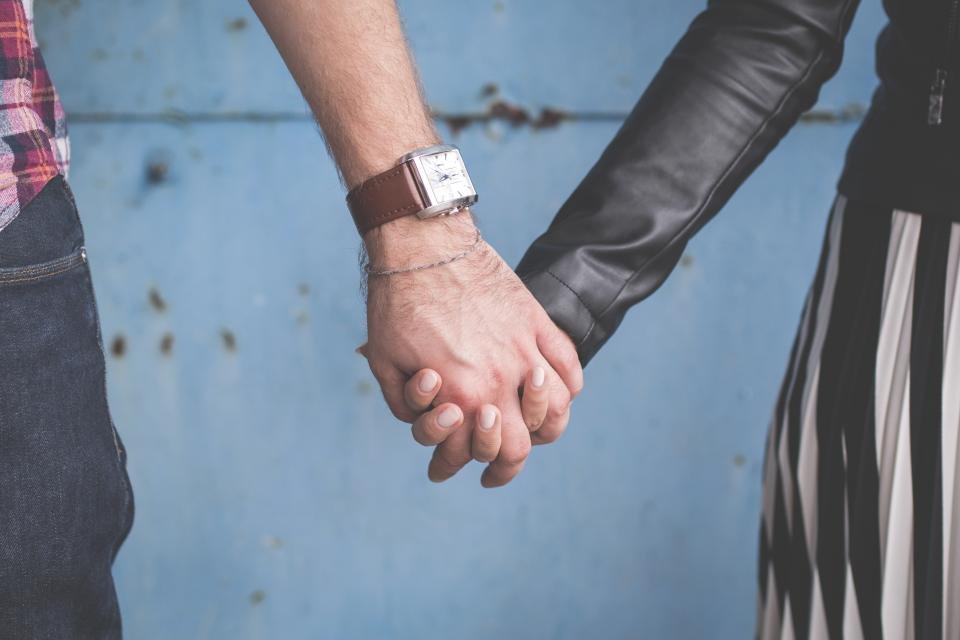Couple holding hands wearing watches – watch gift ideas