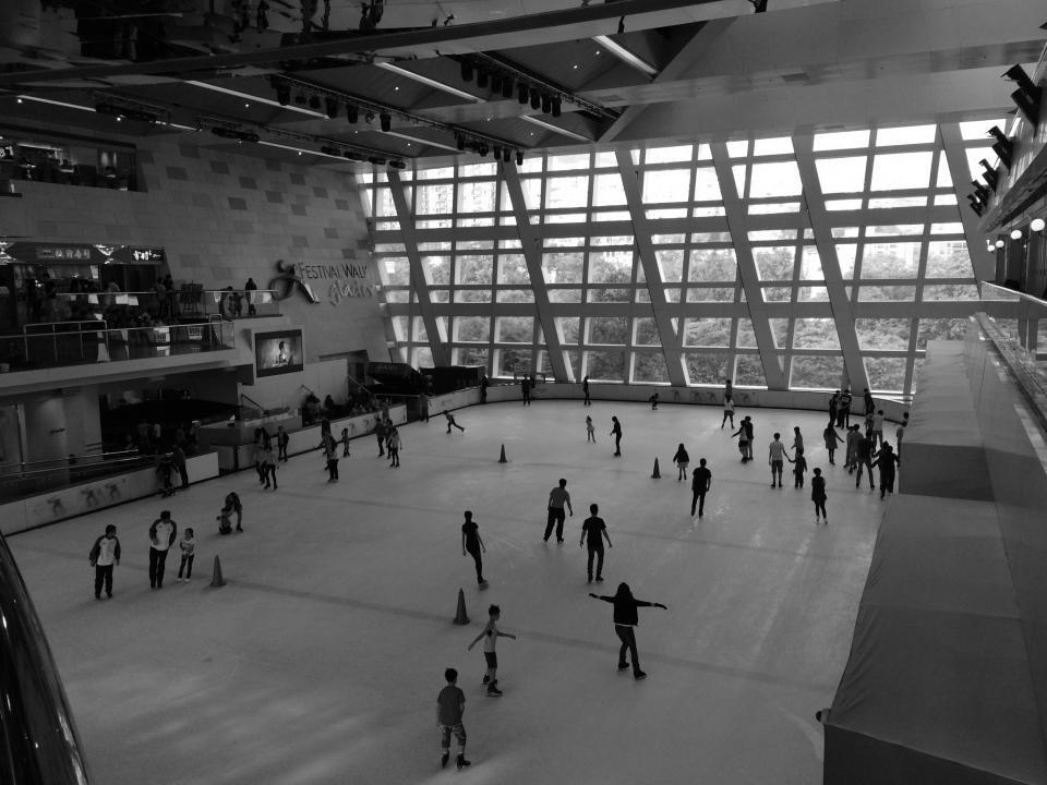 Skaters gliding around an ice rink during the holiday season