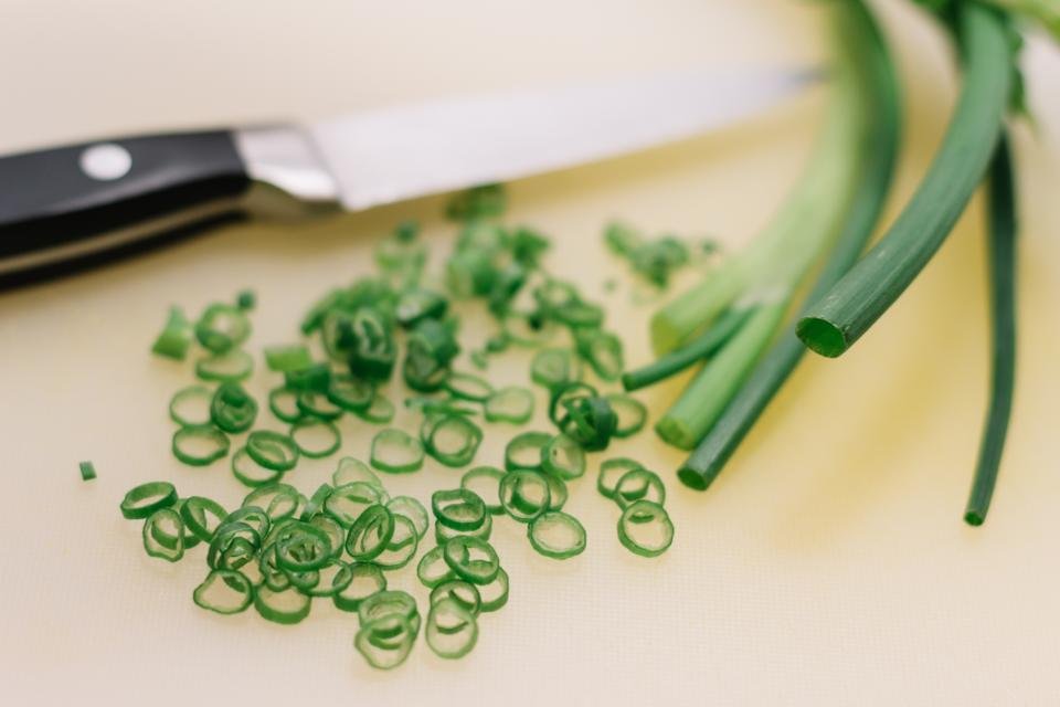 Kitchen knife and sliced vegetables ready for dinner prep