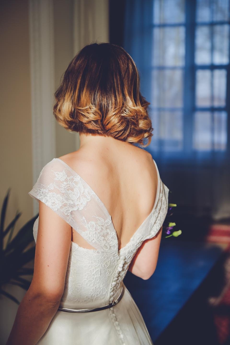 Woman in an elegant lace back evening gown