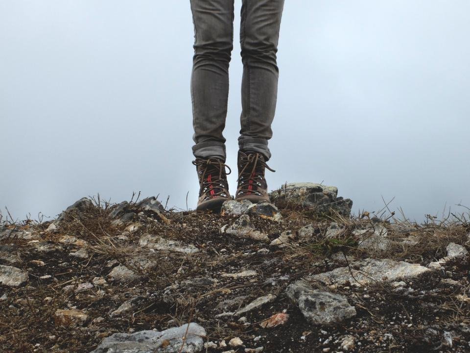 Lace-up leather ankle boots on a rocky trail