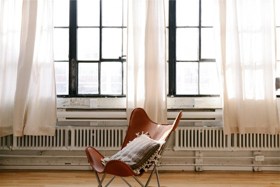 Leather sling chair in a sunny loft living room