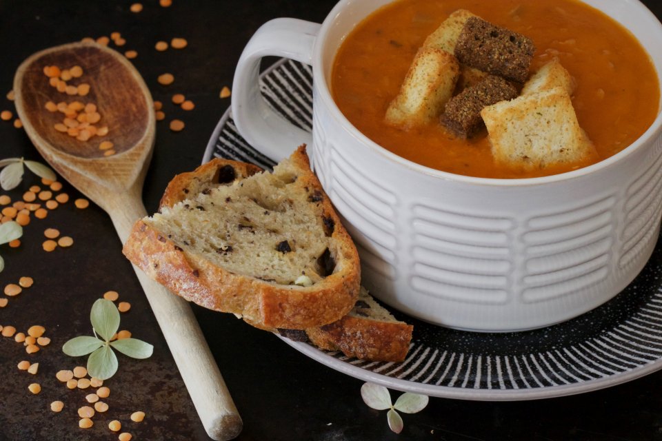Bowl of lentil soup with toasted bread on the side