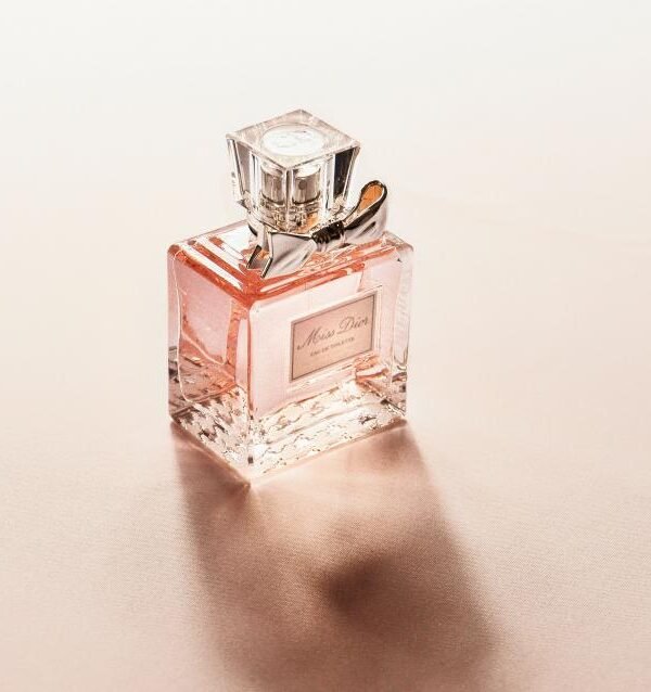 Pink luxury perfume bottle on a soft beige background