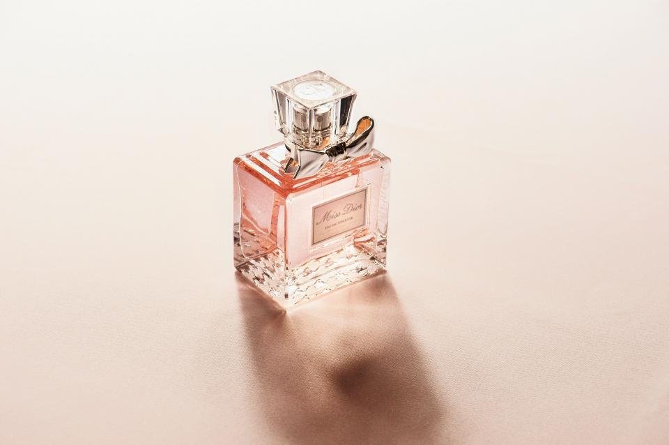 Pink luxury perfume bottle on a soft beige background