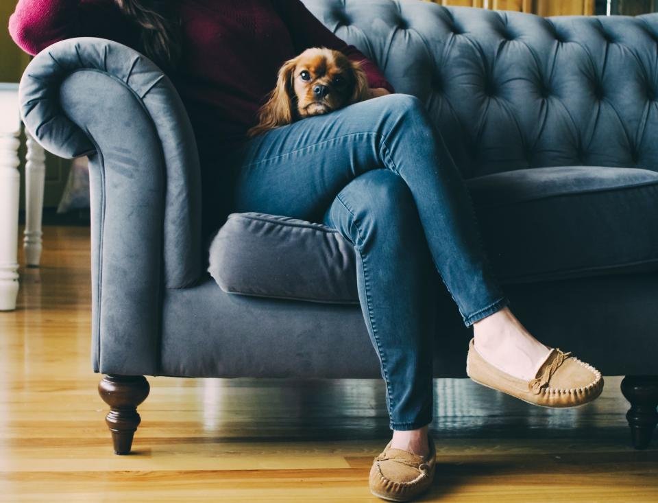 Slippers for women worn while relaxing in an armchair at home