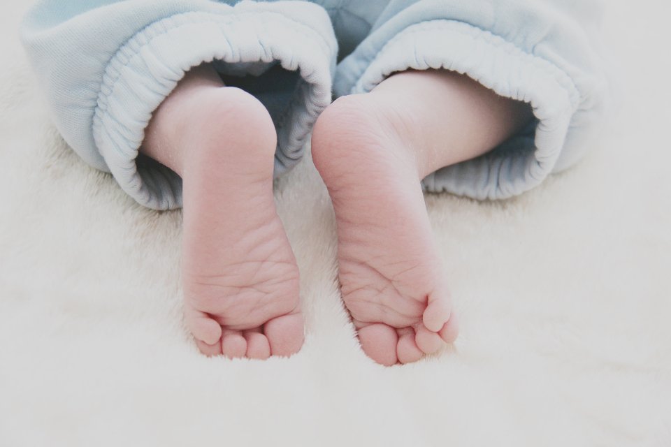 Newborn baby feet, symbolizing gifts for new moms and families