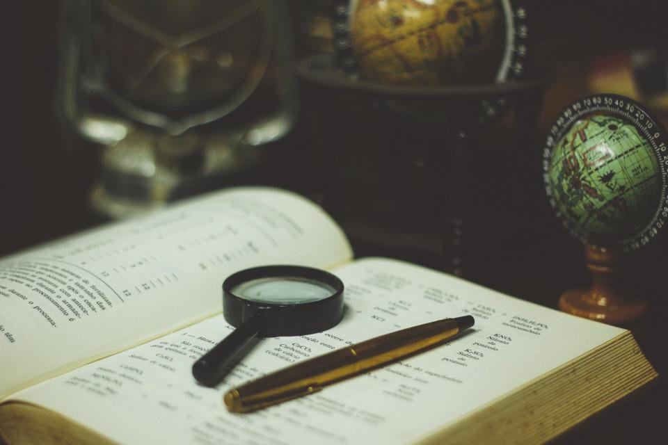 Magnifying glass on a book representing research by female Nobel laureates