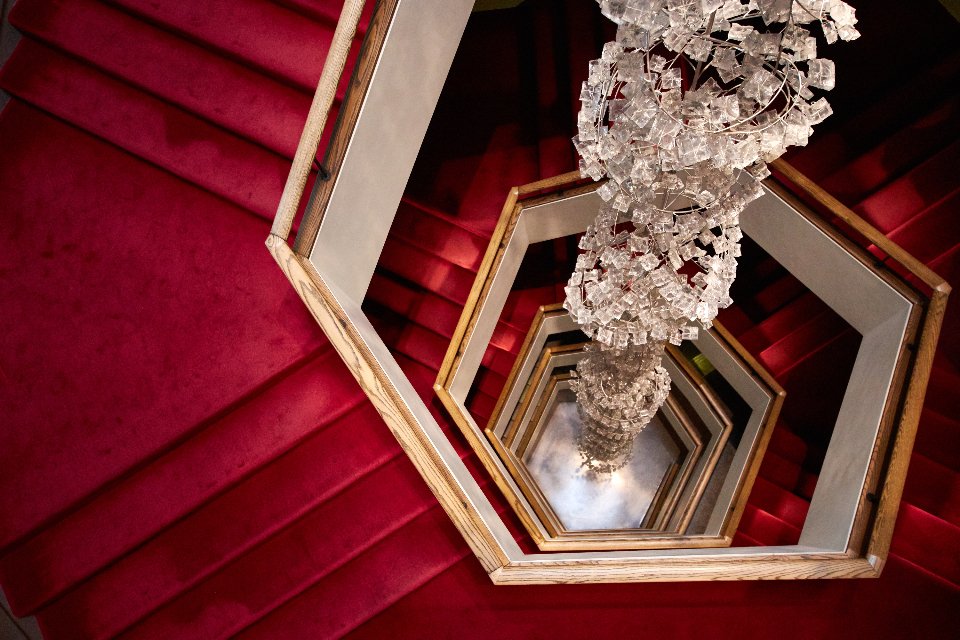 Red carpeted staircase that evokes iconic Oscar dresses