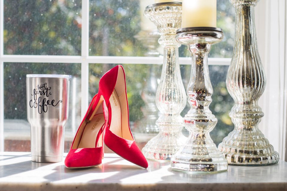Red satin heels and candlesticks recalling iconic Oscar dresses