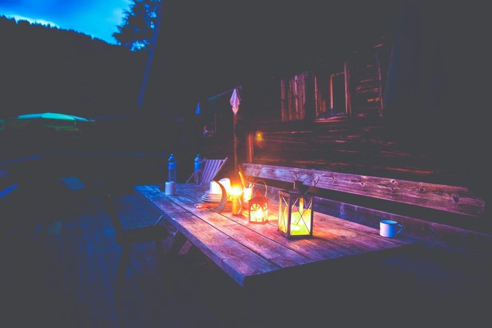Patio heaters keep an outdoor table warm on a cool evening