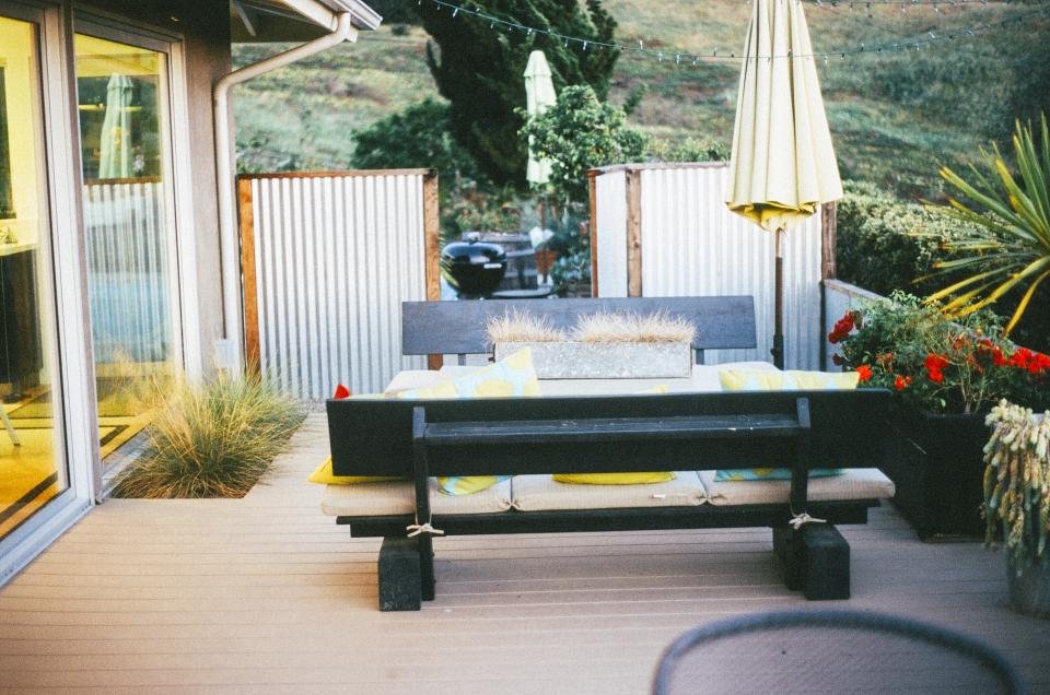 Solar lights brighten a patio and garden deck with outdoor dining