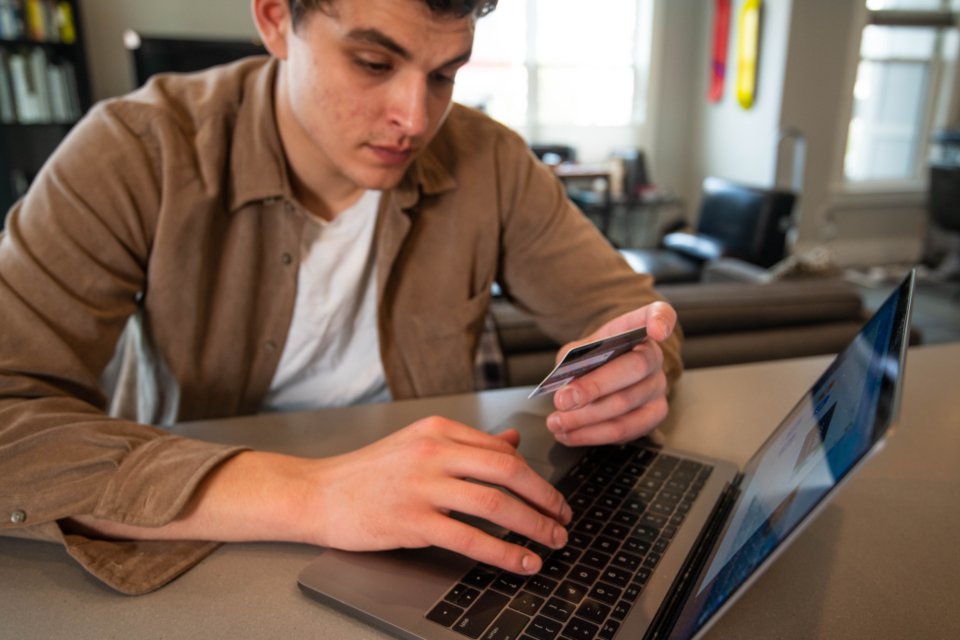 A man paying online with a credit card, a reminder to shop safely on Cyber Monday 2026