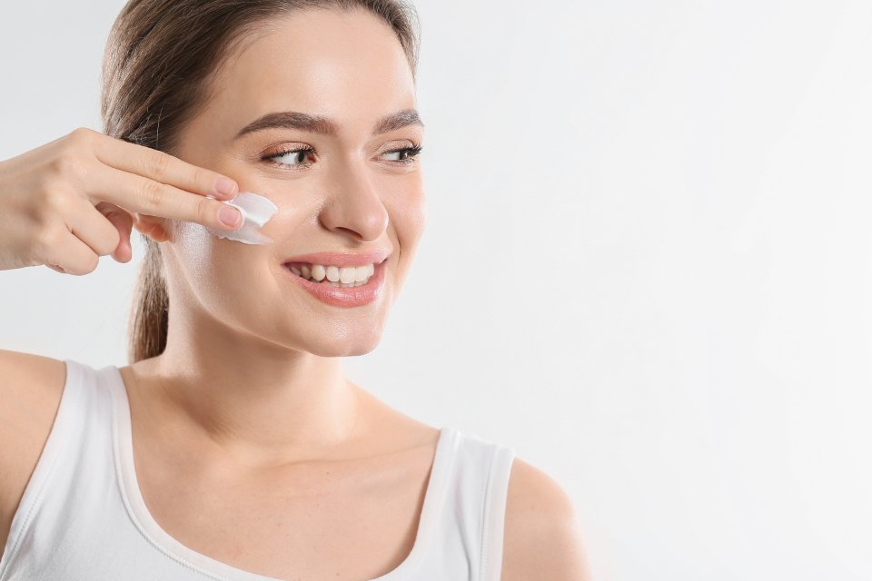 Smiling woman during a simple skincare routine