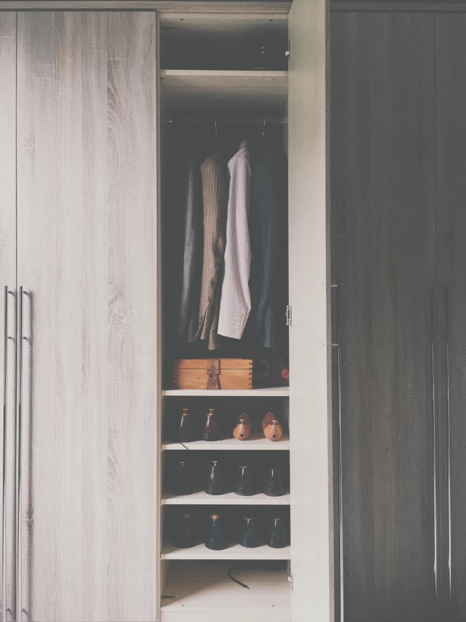 Minimal wardrobe closet with neutral clothes and shoes