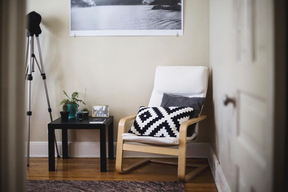 Cozy reading corner with a wooden armchair and cushion