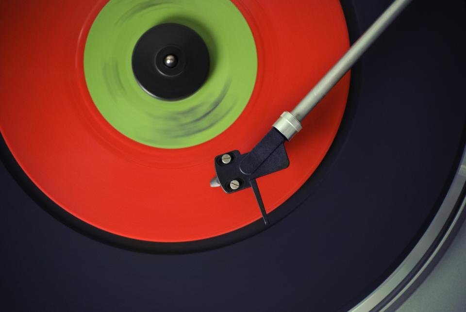 Best record players for beginners playing a red vinyl record