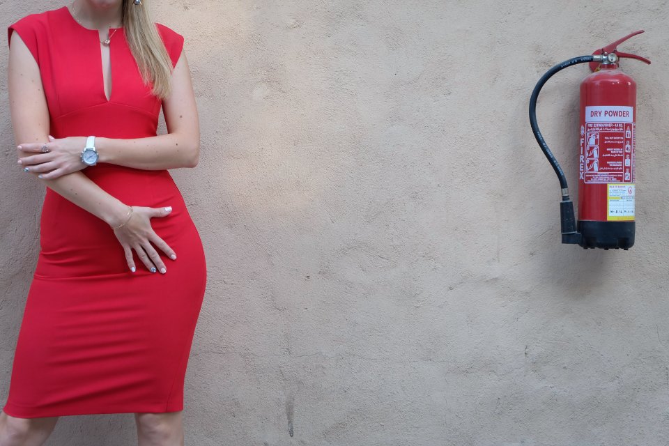 Woman in a fitted red dress for an evening event