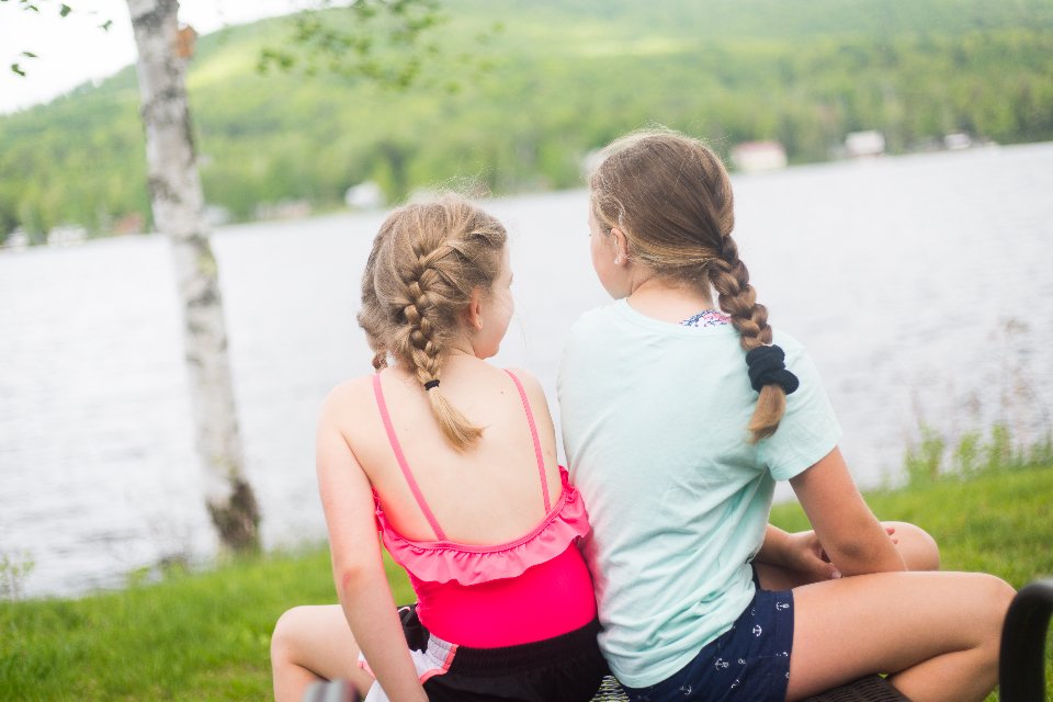 Gifts for sister inspired by two sisters sitting together by a lake