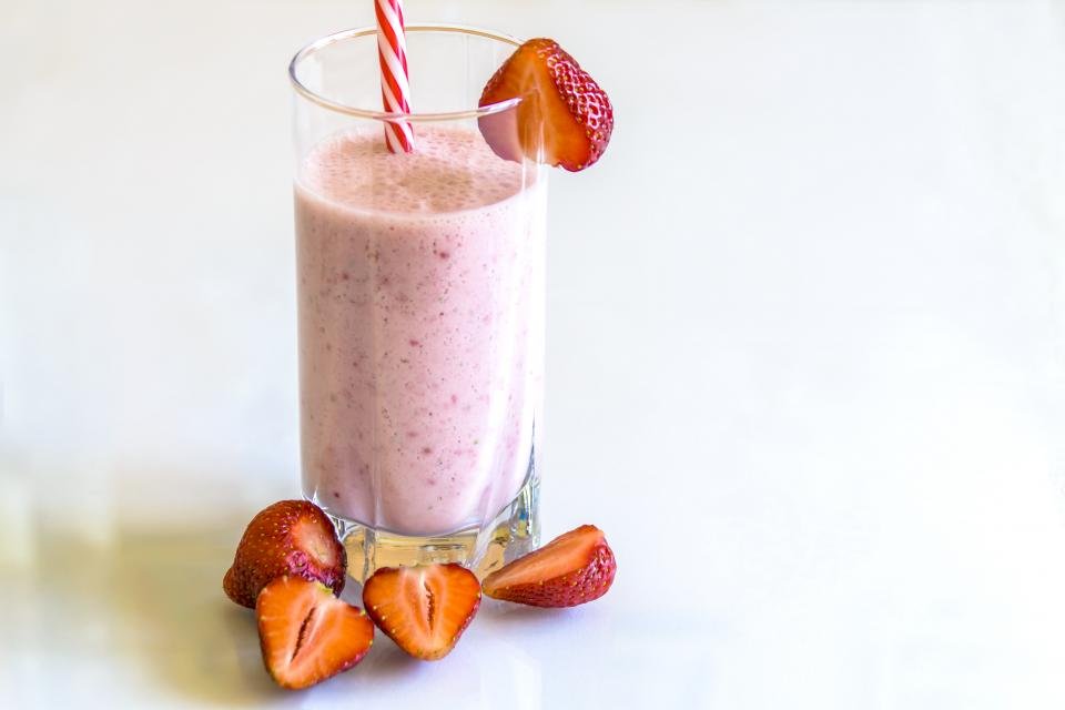 Blenders make a strawberry smoothie served in a tall glass