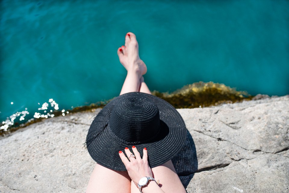 Sun hat and luxury face sunscreen for a day by the sea