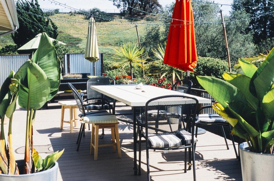 Patio dining area with a table, chairs and umbrellas