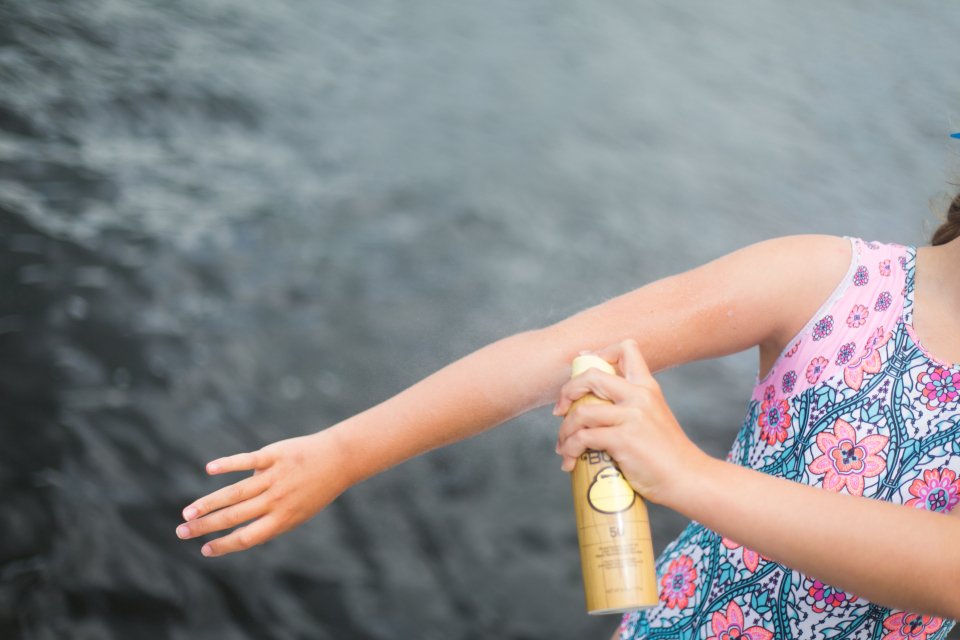 Applying luxury face sunscreen and body SPF before going outside