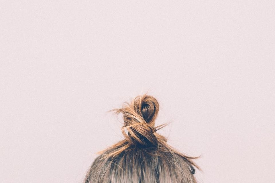 Healthy hair in a top knot after washing with luxury shampoos