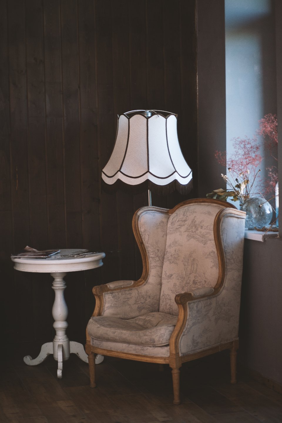 Accent chairs in a vintage wingback style beside a side table