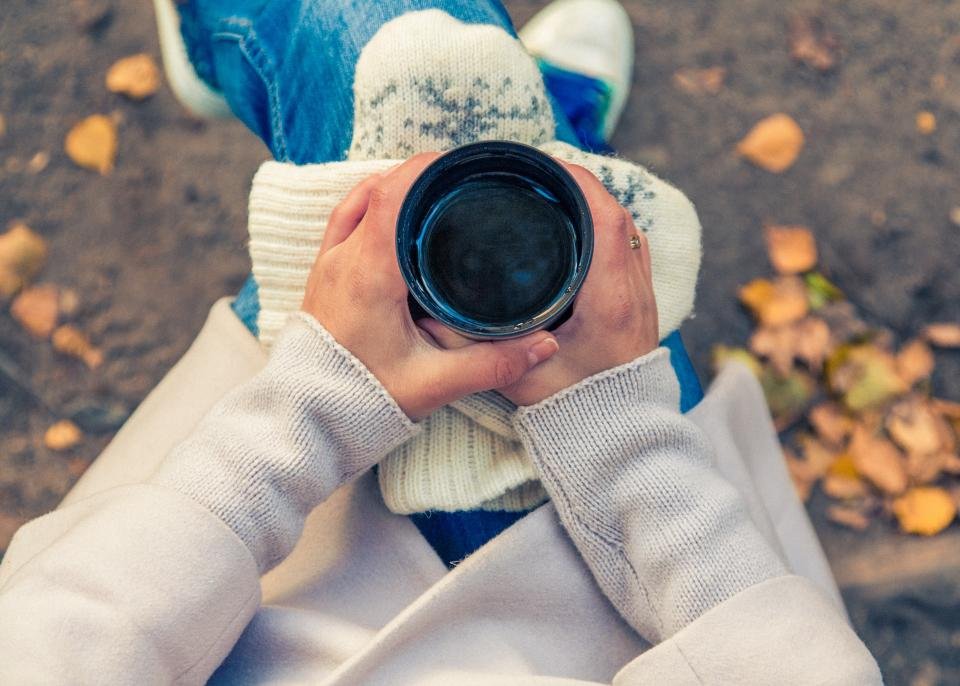 Hands in a cozy sweater holding a warm mug, a comforting gift for grandma