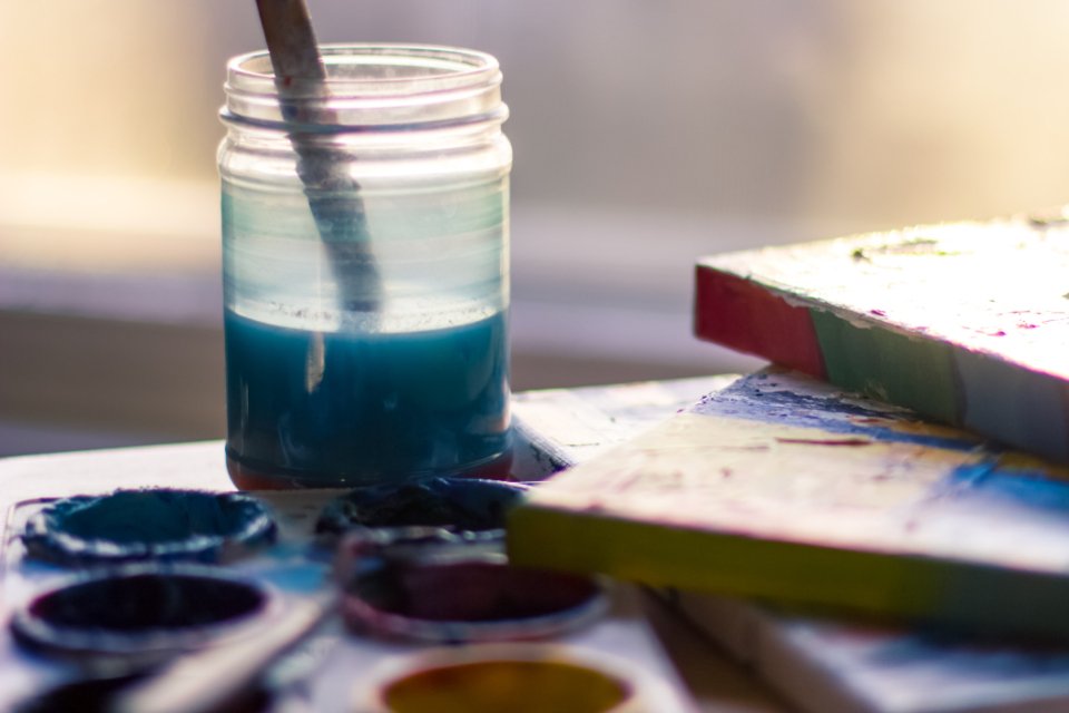 Watercolour paints and brush in a jar, the tools of famous women artists