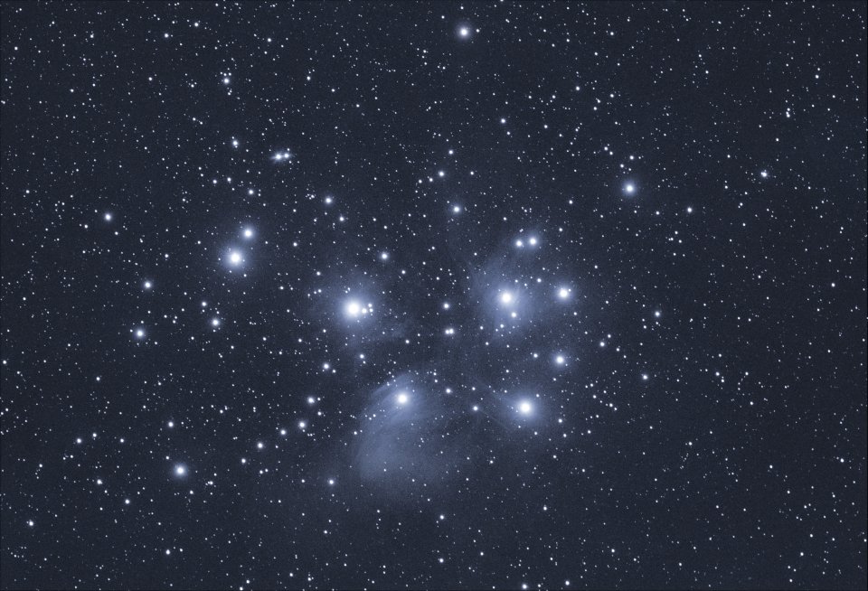 The Pleiades star cluster shining in a clear night sky